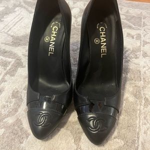 Black Chanel pumps with gold heel